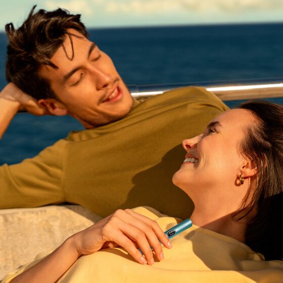 A jade green IQOS ILUMA PRIME Pocket Charger and Holder.