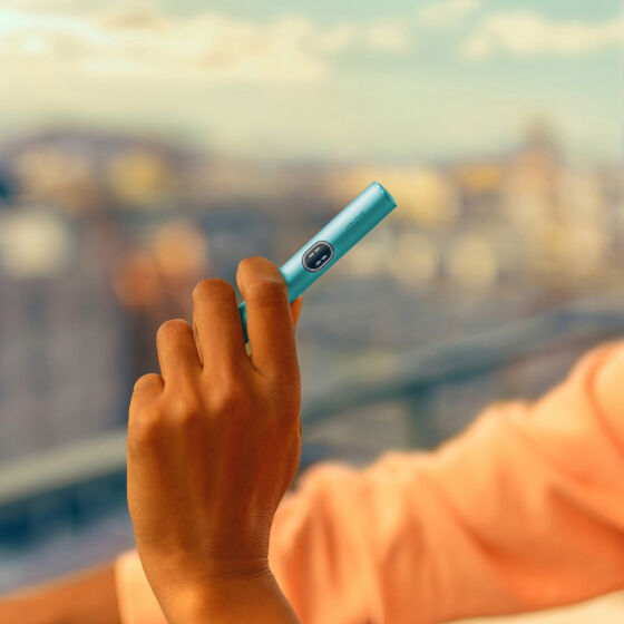 An IQOS ILUMA Pocket Charger in a charging station.