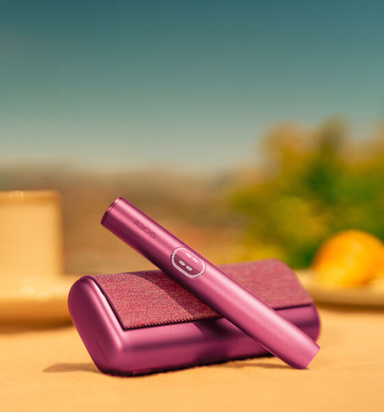 A jade green IQOS ILUMA PRIME Holder and Pocket Charger.