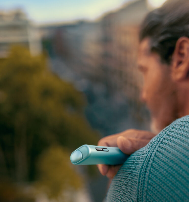 A jade green IQOS ILUMA PRIME Pocket Charger and Holder.