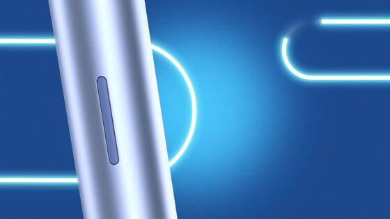 A charging cable being inserted into an IQOS ILUMA PRIME holder.