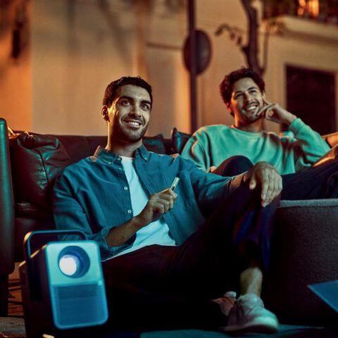 A person holding an unopened IQOS device box.