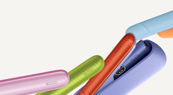 Promotional banner for IQOS ILUMA Prime featuring a sleek black device and charging case on a turquoise background. The text announces a new reduced price of 28 KWD, down from the original 35 KWD, with a note about the recommended retail price.