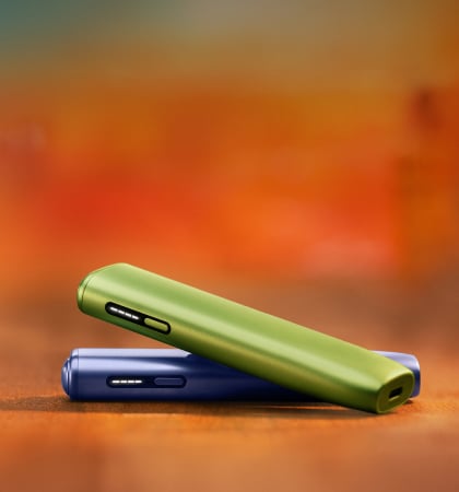 A jade green IQOS ILUMA PRIME Holder and Pocket Charger.